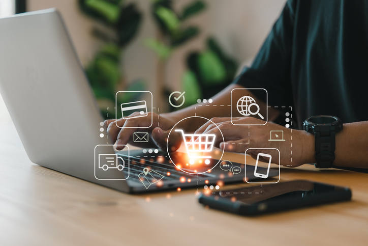 Procurement Technology. Online shopping and e-commerce technology concept, shopper using computer laptop to input order with trolley credit card delivery truck.